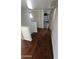 Upstairs hallway with multiple doorways, wood floors and neutral paint, offering a transition between spaces at 239 E Betty Elyse Ln, Phoenix, AZ 85022