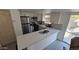 Modern kitchen features stainless steel appliances, a breakfast bar, and opens to a patio at 239 E Betty Elyse Ln, Phoenix, AZ 85022