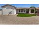 Low maintenance backyard featuring decorative gravel, small lawn, covered patio, and stucco exterior walls at 24812 S Pleasant Ct, Sun Lakes, AZ 85248