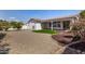 Low maintenance backyard featuring decorative gravel, small lawn, covered patio, and stucco exterior walls at 24812 S Pleasant Ct, Sun Lakes, AZ 85248