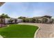 Backyard featuring gravel, artificial turf, and manicured landscaping, designed for low maintenance and enjoyment at 24812 S Pleasant Ct, Sun Lakes, AZ 85248
