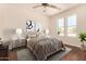 Comfortable bedroom featuring neutral colors, large windows, and modern decor at 24812 S Pleasant Ct, Sun Lakes, AZ 85248