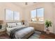 Bright bedroom features a large window, neutral decor, and stylish contemporary furnishings at 24812 S Pleasant Ct, Sun Lakes, AZ 85248