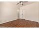 Bedroom with wood-look floors, ceiling fan, closet, and bright white walls at 24812 S Pleasant Ct, Sun Lakes, AZ 85248