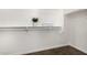 Walk-in closet with dark wood flooring and white shelves with organizers at 24812 S Pleasant Ct, Sun Lakes, AZ 85248