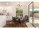 Bright dining area with white cabinets, hardwood floors, and a sliding door to the outdoor patio at 24812 S Pleasant Ct, Sun Lakes, AZ 85248