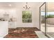 Bright dining area with white cabinets, hardwood floors, and a sliding door to the outdoor patio at 24812 S Pleasant Ct, Sun Lakes, AZ 85248
