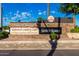 Welcoming entrance to Oakwood Country Club with beautifully landscaped signage and stone accents at 24812 S Pleasant Ct, Sun Lakes, AZ 85248
