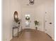 Welcoming entryway features tiled floors, decorative lighting, and stylish console table at 24812 S Pleasant Ct, Sun Lakes, AZ 85248