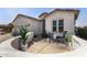 Charming home exterior with outdoor seating area and attached two-car garage at 24812 S Pleasant Ct, Sun Lakes, AZ 85248