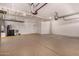 Spacious garage with epoxy floors, storage cabinets, shelving, and a water softener at 24812 S Pleasant Ct, Sun Lakes, AZ 85248