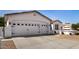 Exterior shot of a three-car garage with white doors and attractive architectural details at 24812 S Pleasant Ct, Sun Lakes, AZ 85248