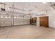 Spacious garage with epoxy floors, storage cabinets, shelving, and two doors at 24812 S Pleasant Ct, Sun Lakes, AZ 85248