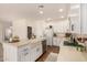 Bright kitchen with white cabinets, stainless steel appliances, a farmhouse sink, and wood floors at 24812 S Pleasant Ct, Sun Lakes, AZ 85248