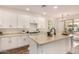 Bright kitchen with white cabinets, stainless steel appliances, an island and wood floors at 24812 S Pleasant Ct, Sun Lakes, AZ 85248
