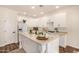 Bright kitchen with white cabinets, stainless steel appliances, an island and wood floors at 24812 S Pleasant Ct, Sun Lakes, AZ 85248