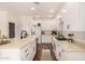 Bright kitchen with white cabinets, stainless steel appliances, a farmhouse sink, and wood floors at 24812 S Pleasant Ct, Sun Lakes, AZ 85248