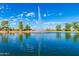 Picturesque lake view with a fountain and surrounding homes, offering a serene and scenic atmosphere at 24812 S Pleasant Ct, Sun Lakes, AZ 85248