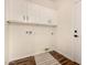 Functional laundry room with white cabinets for storage and a door to outside at 24812 S Pleasant Ct, Sun Lakes, AZ 85248