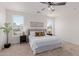 Bright main bedroom showcasing a comfortable bed, ceiling fan, and windows with natural light at 24812 S Pleasant Ct, Sun Lakes, AZ 85248
