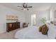 Spacious main bedroom featuring a dresser, chair, and access to the bathroom at 24812 S Pleasant Ct, Sun Lakes, AZ 85248