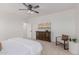 Well-lit main bedroom showcasing a dresser, chair, and stylish décor at 24812 S Pleasant Ct, Sun Lakes, AZ 85248