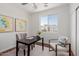 This home office has a calming atmosphere with stylish chairs and decorative artwork at 24812 S Pleasant Ct, Sun Lakes, AZ 85248