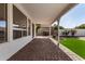 Covered patio featuring brick pavers and views of the backyard at 24812 S Pleasant Ct, Sun Lakes, AZ 85248
