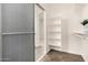 Bright walk-in closet with custom shelving, rod, and sliding door, providing ample storage space at 24812 S Pleasant Ct, Sun Lakes, AZ 85248