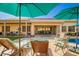 Relaxing backyard with lounge chairs by the pool and covered patio for outdoor dining and lounging at 26991 N 97Th Ln, Peoria, AZ 85383
