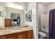 Bathroom with dual sinks and granite countertop, as well as a shower-tub combination at 26991 N 97Th Ln, Peoria, AZ 85383