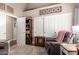 Relaxing bedroom with comfortable recliner, patterned rug, and closet with sliding doors at 26991 N 97Th Ln, Peoria, AZ 85383