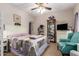 Comfortable bedroom with ceiling fan, chair, dresser, and decorative furnishings at 26991 N 97Th Ln, Peoria, AZ 85383