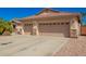 Attractive home featuring a three-car garage with decorative stone accents at 26991 N 97Th Ln, Peoria, AZ 85383