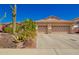 Charming single-story home with a well-maintained desert landscape and a spacious three-car garage at 26991 N 97Th Ln, Peoria, AZ 85383