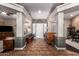 Elegant foyer showcasing tile flooring, decorative columns, and abundant natural light at 26991 N 97Th Ln, Peoria, AZ 85383