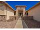 Inviting front entrance featuring decorative stone accents and gated courtyard at 26991 N 97Th Ln, Peoria, AZ 85383