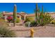 Inviting single-story home showcasing xeriscaping, desert plants, and stone accents at 26991 N 97Th Ln, Peoria, AZ 85383