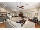 Open concept living room with beamed ceilings, modern decor, and lots of natural light at 26991 N 97Th Ln, Peoria, AZ 85383