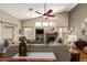 Comfortable living room with ceiling fan, fireplace, neutral walls and furnishings and lots of natural light at 26991 N 97Th Ln, Peoria, AZ 85383