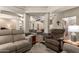 Open concept living room with tile flooring, neutral walls and furnishings and decorative columns at 26991 N 97Th Ln, Peoria, AZ 85383