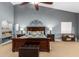 Well-lit main bedroom featuring a king-size bed, side tables, and carpeted floors at 26991 N 97Th Ln, Peoria, AZ 85383