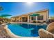 Sparkling pool and landscaped backyard create a private oasis perfect for outdoor enjoyment and relaxation at 26991 N 97Th Ln, Peoria, AZ 85383