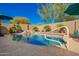 Beautiful backyard pool with lush landscaping and waterfall feature, creating a serene outdoor retreat at 26991 N 97Th Ln, Peoria, AZ 85383