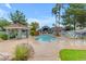 Community pool showcasing clear water, a rock feature, lounging area, and lush landscaping at 2929 W Yorkshire Dr # 2013, Phoenix, AZ 85027