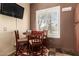 Cozy breakfast nook features a round table with seating for four and a large window with white shutters at 30411 N 42Nd Pl, Cave Creek, AZ 85331