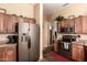 Open kitchen featuring stainless steel refrigerator, wood cabinets, and granite countertops at 30411 N 42Nd Pl, Cave Creek, AZ 85331