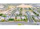 A bird's-eye view of a residential neighborhood with mature trees and nearby open spaces at 3220 N 136Th Dr, Avondale, AZ 85392