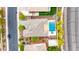 Overhead shot of a suburban backyard with a pool, spa, desert landscaping, green grass, and the home's roof at 3220 N 136Th Dr, Avondale, AZ 85392
