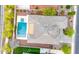 An aerial perspective displays the backyard pool, spa, patio, and lush landscaping surrounding this well-kept residence at 3220 N 136Th Dr, Avondale, AZ 85392